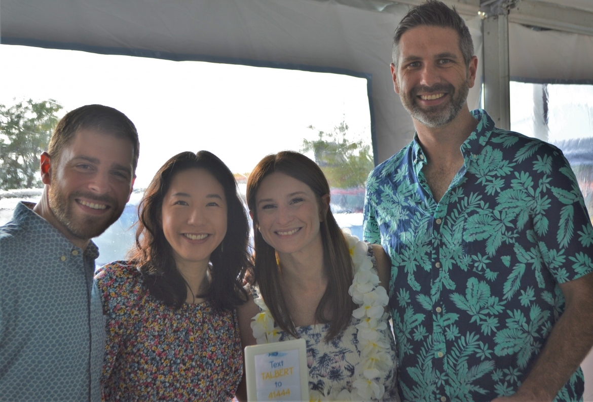 Four people smiling